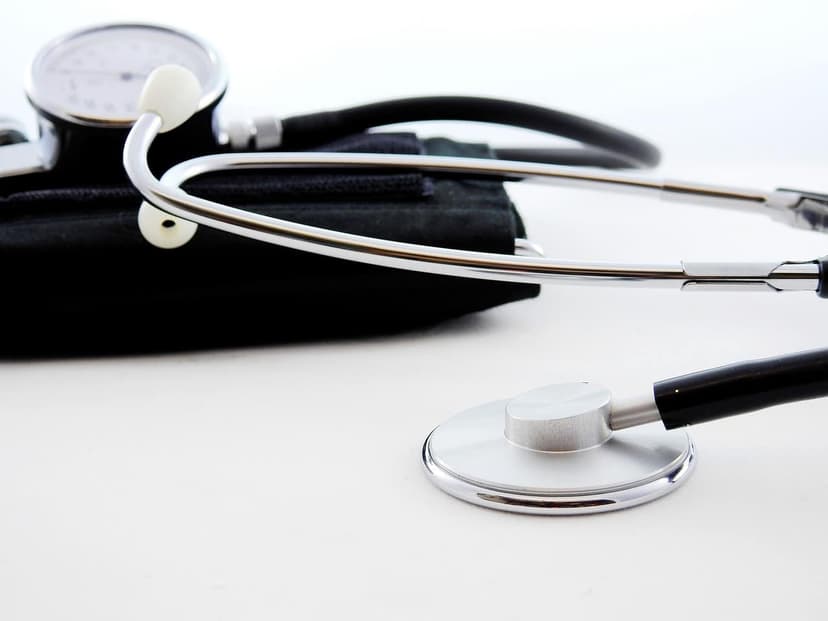 A doctor checking blood pressure in a medical office