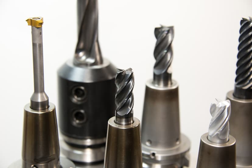 A set of drill bits laid out on a workbench