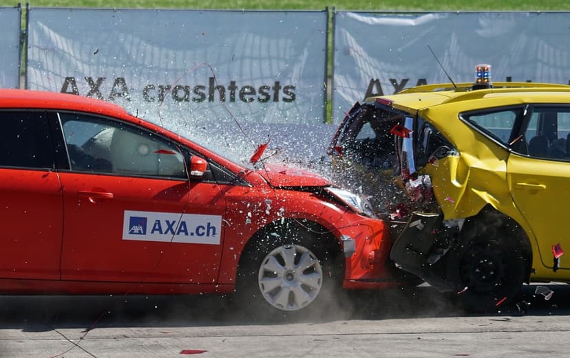 Two cars colliding during a staged vehicle crash test